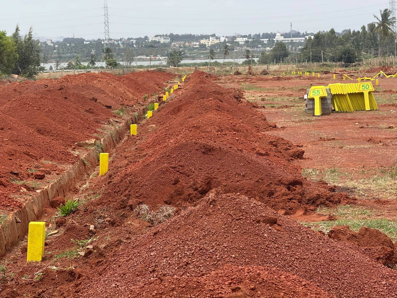 KND Smart City — plot demarcation work with lake view in the distance